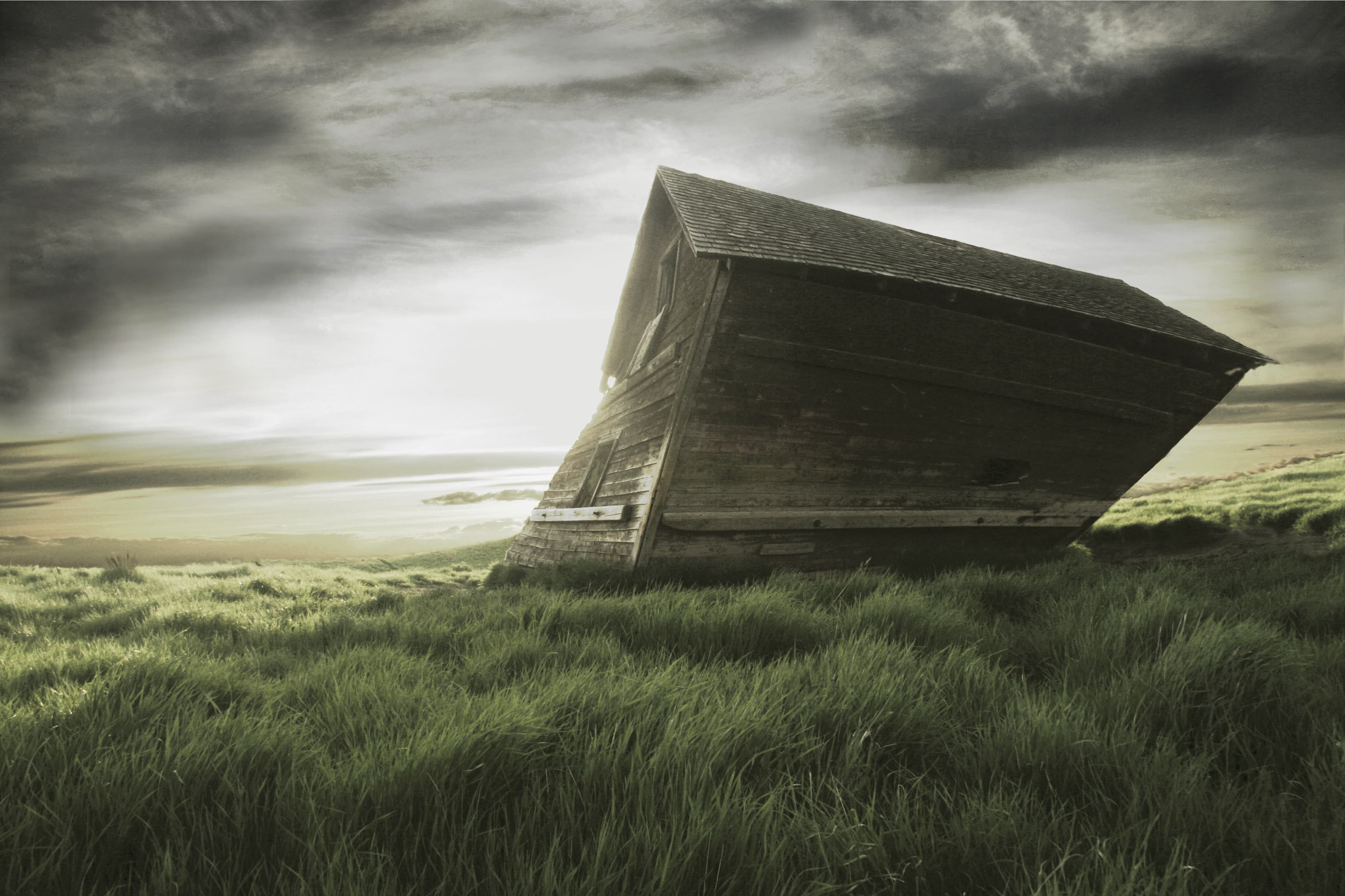 Weathered Alberta shack beneath a dramatic prairie sky