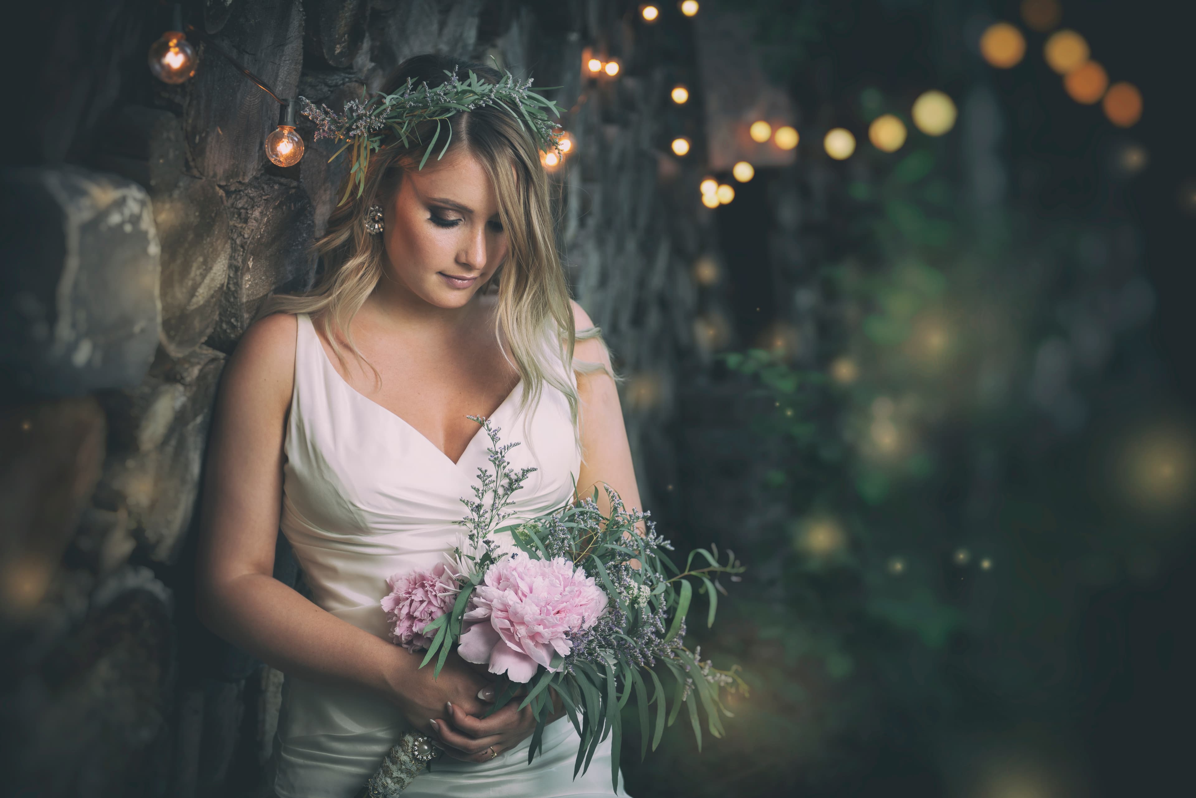Bride photographed among warm woodland lights