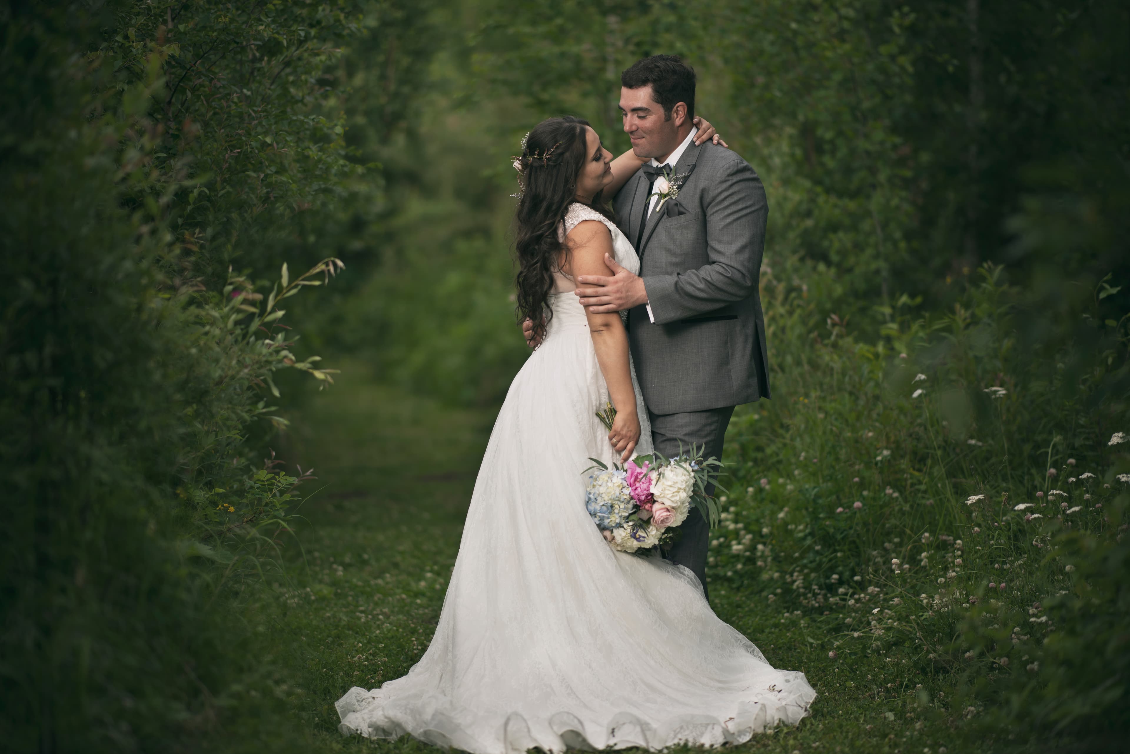 Newlywed couple photographed on a woodland path